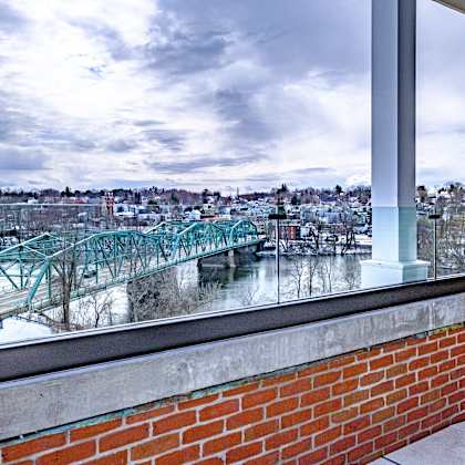 a view from a window of a bridge over a river.