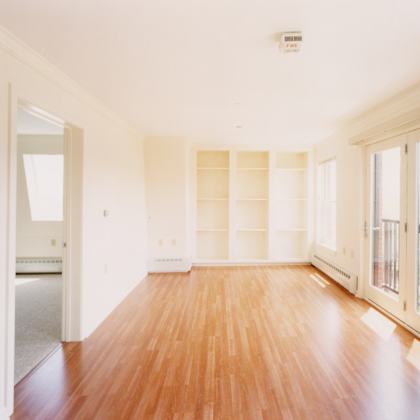 a room with wooden floors and white walls.