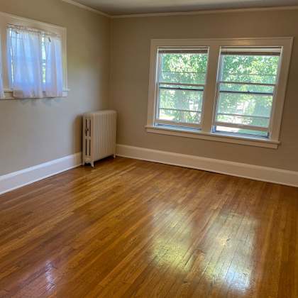 a room with a wooden floor and a window.