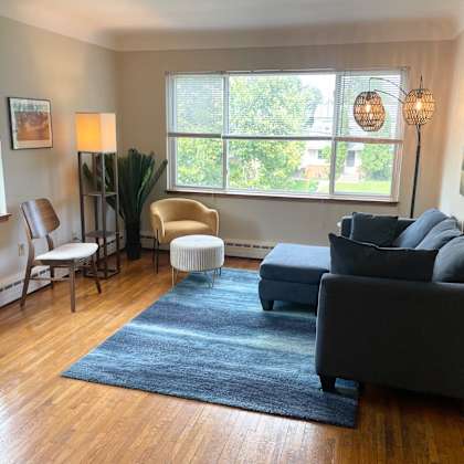 well-lit living room with large picture window.
