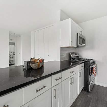 a kitchen with a black countertop at ashlawn at southern towers, virginia