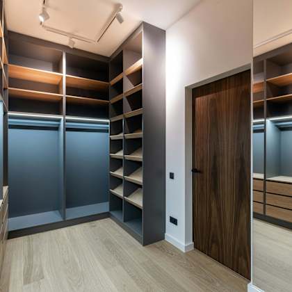 a room with a wooden floor and a brown door.