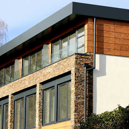 a modern house with a combination of brick and wood siding.