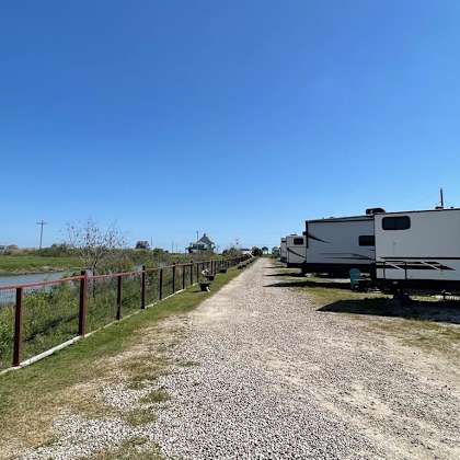 a gravel path leads to a row of rvs.