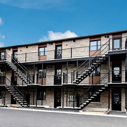 a building with a black staircase and a black door.