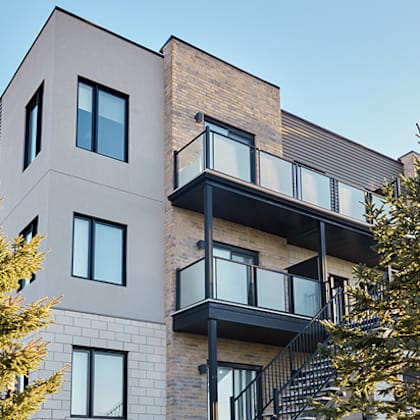 a modern building with a balcony and a staircase.