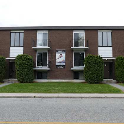 apartment building with a sign that says "sunset park apartments".