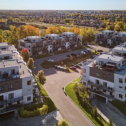 a bird's eye view of a residential area with multiple buildings and a parking lot.