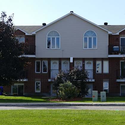a large two story building with a balcony on the second floor.