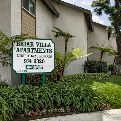 a sign for briar villa apartments is in front of a building.