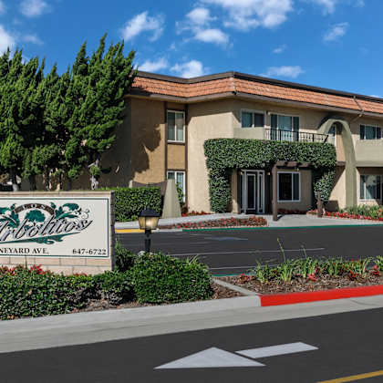 a building with a sign that says los arbolitos in front of it.