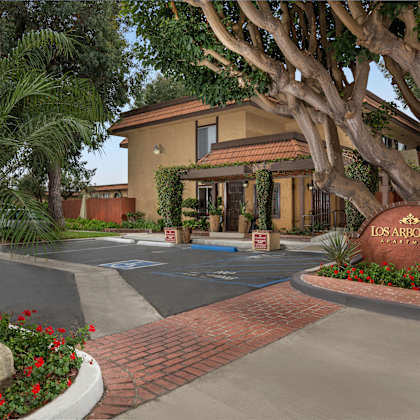 the entrance to a residential complex named los arbolitos.
