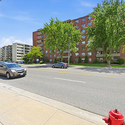 a red fire hydrant is on the sidewalk next to a street.