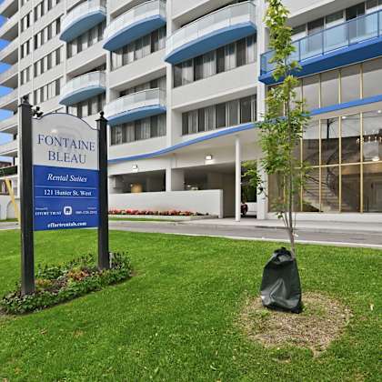 a sign for fontaine bleau residences stands in front of a building.