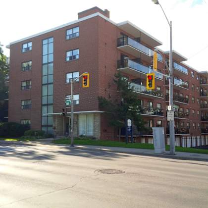 a red brick building with a balcony on the second floor.