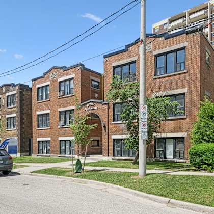 a street view of a residential area with a car parked on the side of the road.