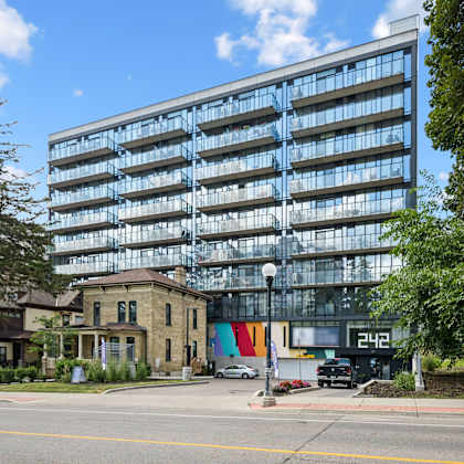 modern glass facade building with balconies at ophelia on queen apartments, ontario