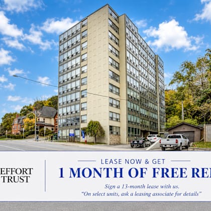 a tall building with a sign offering 1 month of free rent.