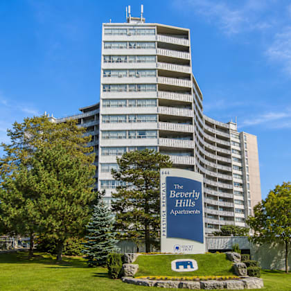 a tall building with a sign that says "the beverly hills apartments".
