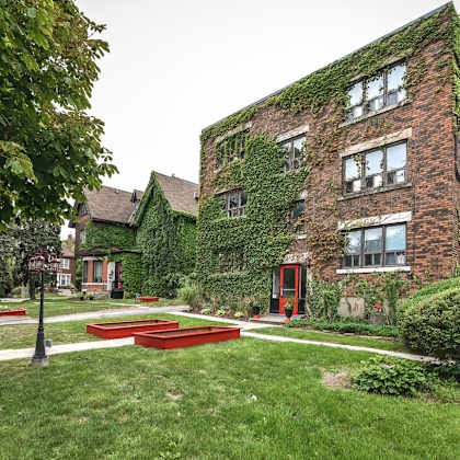 a red brick building with ivy growing on it.