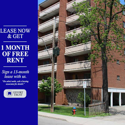 a tall building with a sign offering free rent for the first month.
