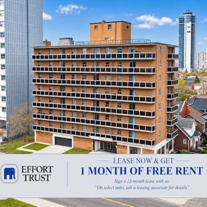 a large building with a sign offering a free month of rent.