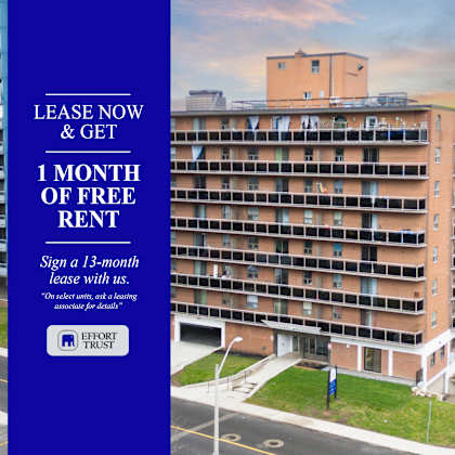 large building with a blue sign offering a free month of rent.