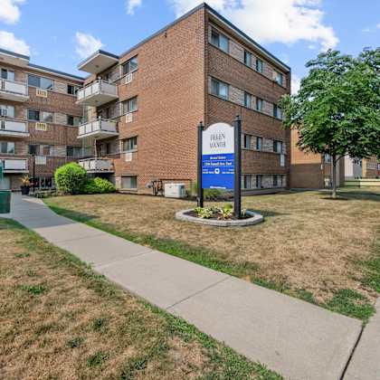 a large brick building with a sign that says "bella vista apartments".