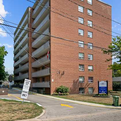 a tall brick building with a sign that says "only" in front of it.
