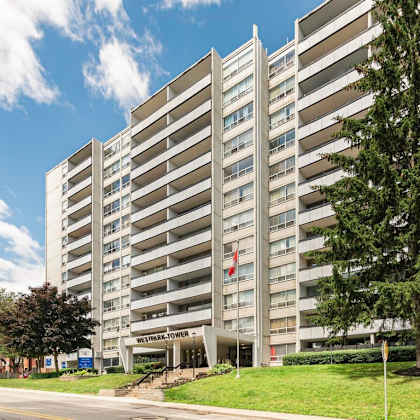a tall building with the words "westhills towers" on the front.