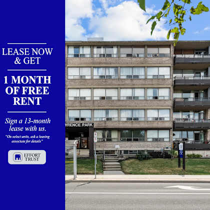 a large building with a blue sign offering free rent for the first month.