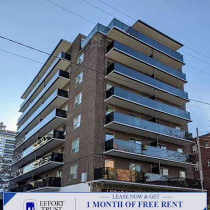 a tall building with a sign that says "effort trust 1 month of free rent".