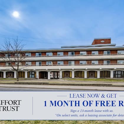 a large building with a sign offering a free month of rent.