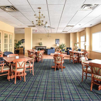 a large room with tables and chairs and a chandelier.