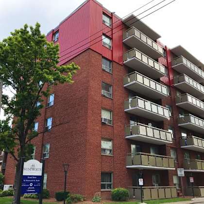 the building is made of red bricks and has a sign that says "the beaumont".
