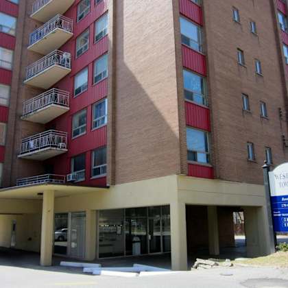a tall building with a sign that says westgate towers.
