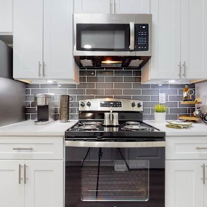 a kitchen with a stove, refrigerator, and microwave at embry hills, atlanta, 30042
