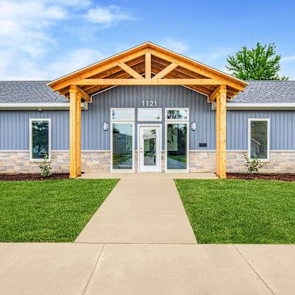a building with a wooden front entrance and a glass door at poplar place apartments, springfield, il 62703
