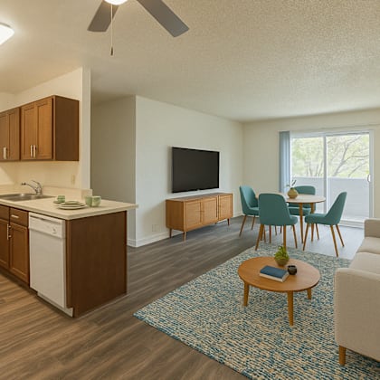 a living room with a couch, chairs, and a television at oak center apartments, oakland