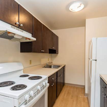 a kitchen with a white stove and a white refrigerator at mohican apartments, connecticut, 06320