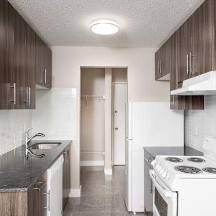 a kitchen with a white stove and a white refrigerator.