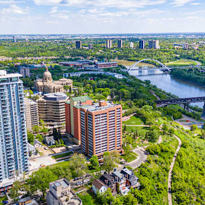 a cityscape with a river and a bridge in the background.
