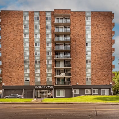 oliver tower is a tall brick building with many windows.