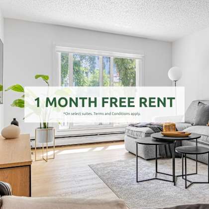 a living room with a grey sofa and a coffee table, and a sign that says "1 month free rent".