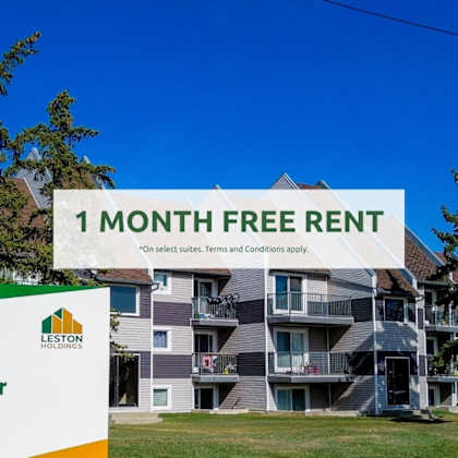 a large building with a sign offering a free one month rent.