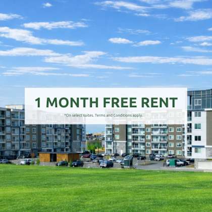 a sign offering a free one month rent is displayed in front of apartment buildings.