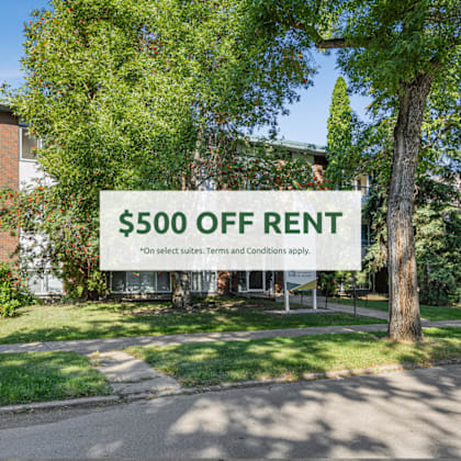 a sign advertising $500 off rent is displayed in a sunny area.