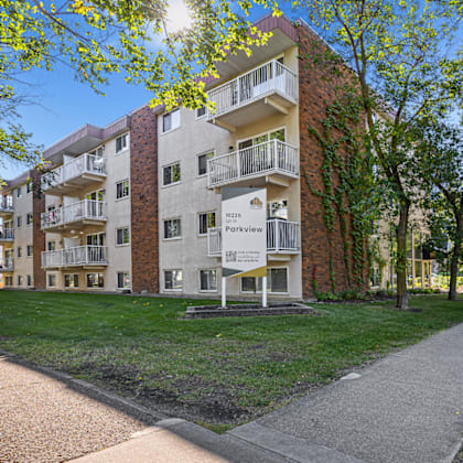apartment building with a walkway in front of it.
