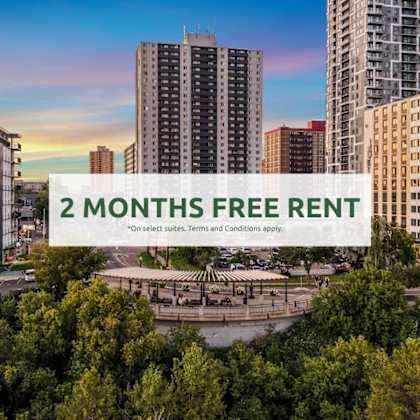 a cityscape with apartment buildings and a sign offering 2 months free rent.