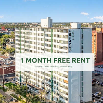 a tall building with a sign that reads "1 month free rent" in front of a cityscape.